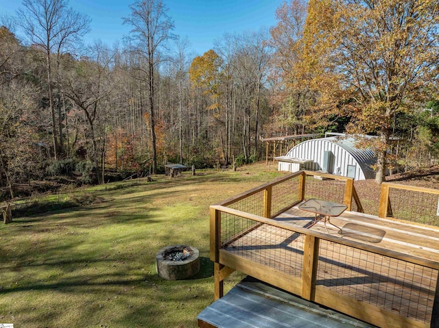 wooden terrace with a lawn and a shed