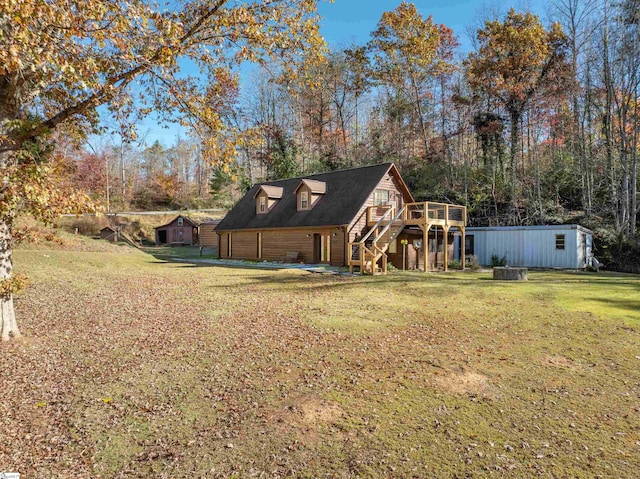 view of yard with a wooden deck and a shed