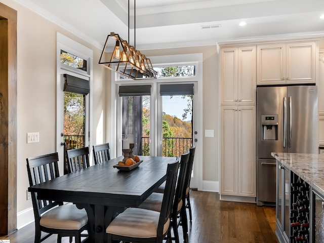 dining area featuring wine cooler and dark wood-type flooring