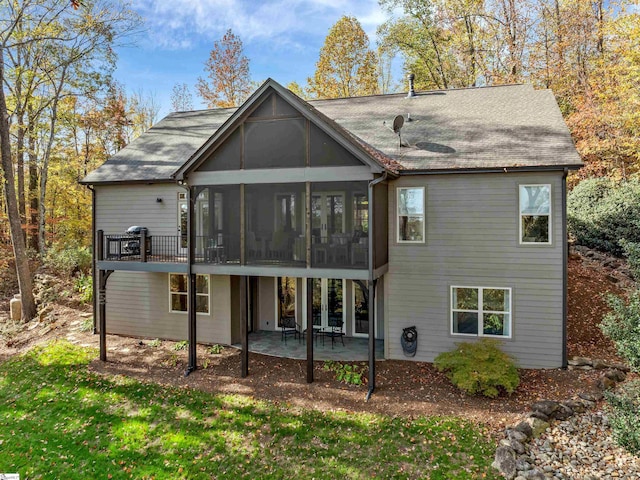 back of house with a patio area and a sunroom