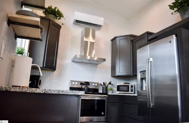 4A/B Vest St, Travelers Rest, SC 29690 - kitchen with appliances with stainless steel finishes, a wall unit AC, wall chimney range hood, decorative backsplash, and light stone countertops