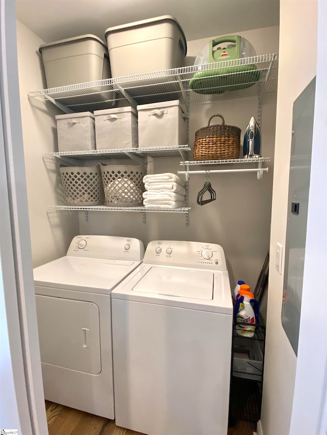 laundry area with washer and dryer and hardwood / wood-style flooring