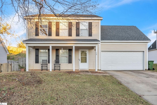 view of front property featuring covered porch, a garage, and a front lawn