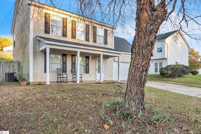 view of front of property with cooling unit, covered porch, and a garage