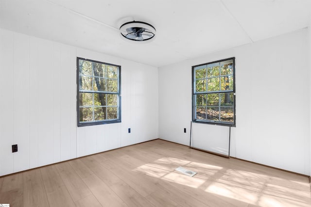 empty room featuring plenty of natural light and light wood-type flooring