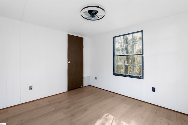 empty room with light hardwood / wood-style flooring