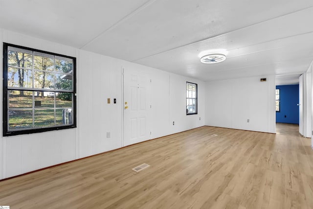 unfurnished room with plenty of natural light and light wood-type flooring