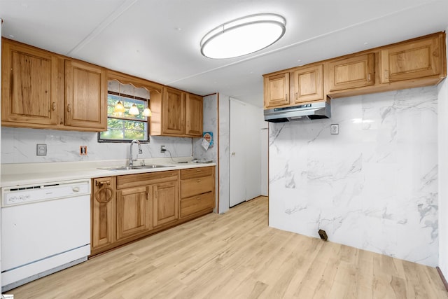 kitchen with decorative backsplash, dishwasher, light wood-type flooring, and sink