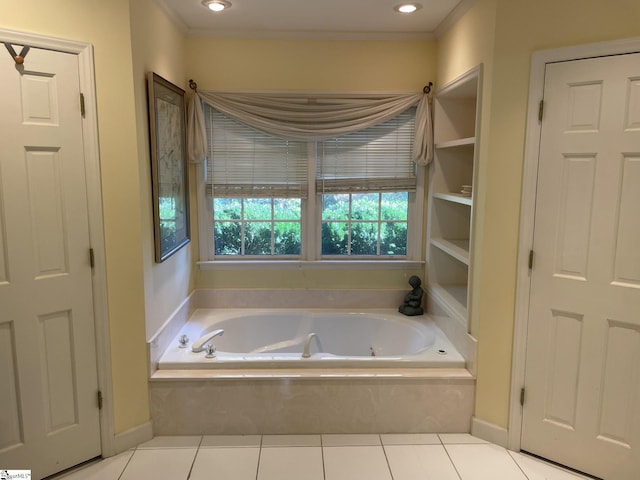 bathroom with tile patterned floors and a relaxing tiled tub