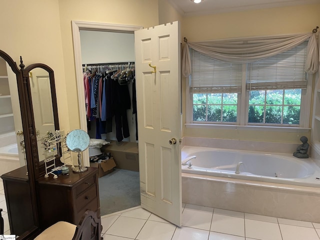 bathroom with a bathing tub, tile patterned flooring, and crown molding