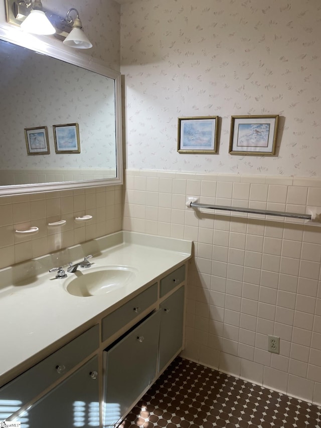 bathroom with tile patterned flooring, vanity, and tile walls