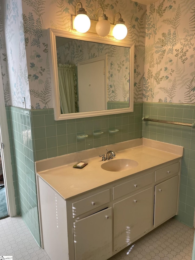 bathroom featuring vanity, tile patterned floors, and tile walls