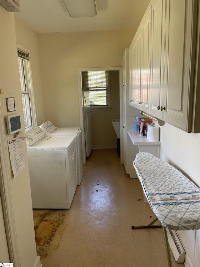 laundry room featuring cabinets and separate washer and dryer