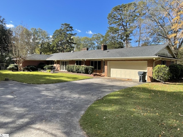 single story home with a front yard and a garage