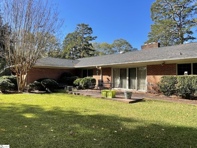 rear view of property featuring a patio area and a lawn