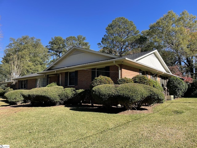 view of side of home with a lawn