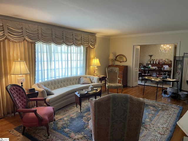 living room with a chandelier, hardwood / wood-style flooring, and ornamental molding