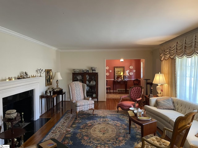 living room with wood-type flooring and ornamental molding