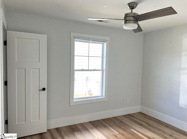 spare room featuring ceiling fan and light wood-type flooring