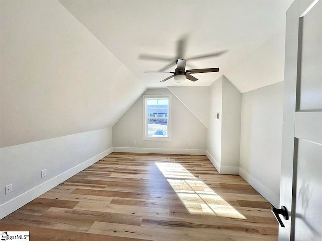 additional living space with ceiling fan, light hardwood / wood-style floors, and vaulted ceiling