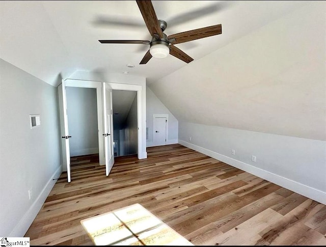 bonus room featuring ceiling fan, lofted ceiling, and light wood-type flooring