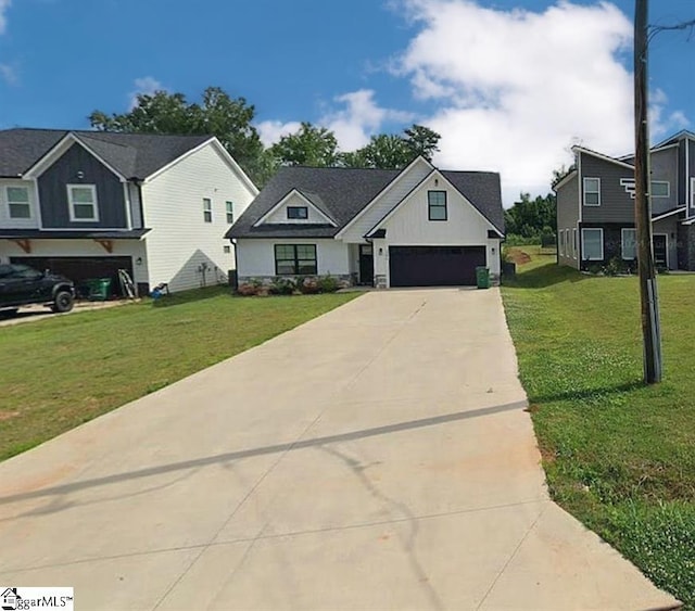 view of front of property featuring a garage and a front lawn