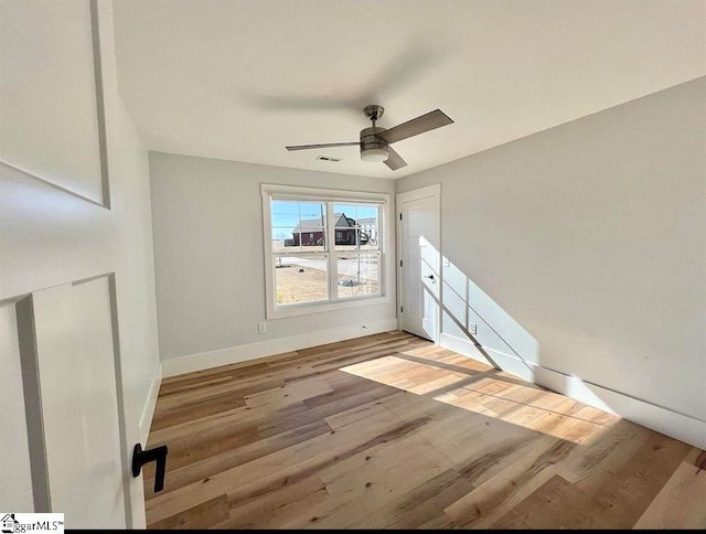 unfurnished room featuring ceiling fan and light hardwood / wood-style floors