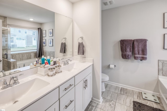 bathroom featuring vanity, toilet, and a bath