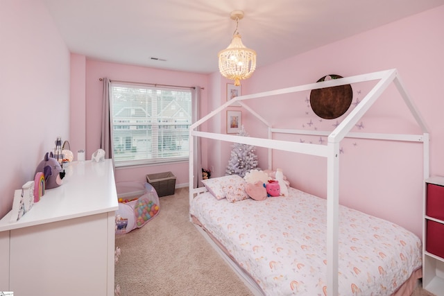 carpeted bedroom with an inviting chandelier