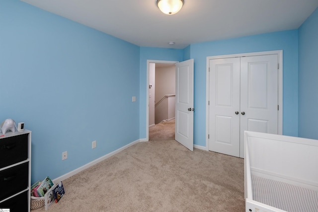 bedroom featuring light carpet and a closet