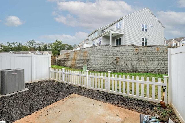 view of yard with central air condition unit and a patio area