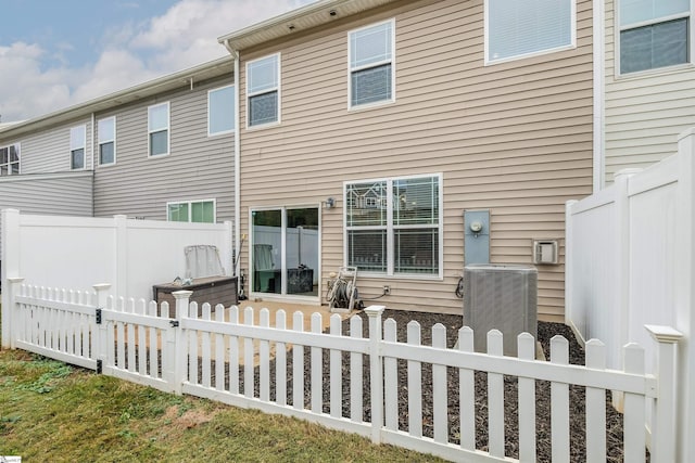 rear view of property featuring cooling unit