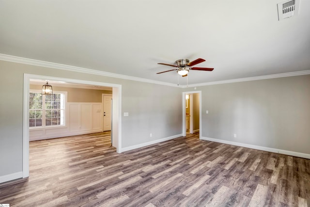 unfurnished room with wood-type flooring, ceiling fan with notable chandelier, and crown molding