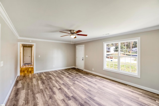 spare room with light hardwood / wood-style flooring, ceiling fan, and crown molding