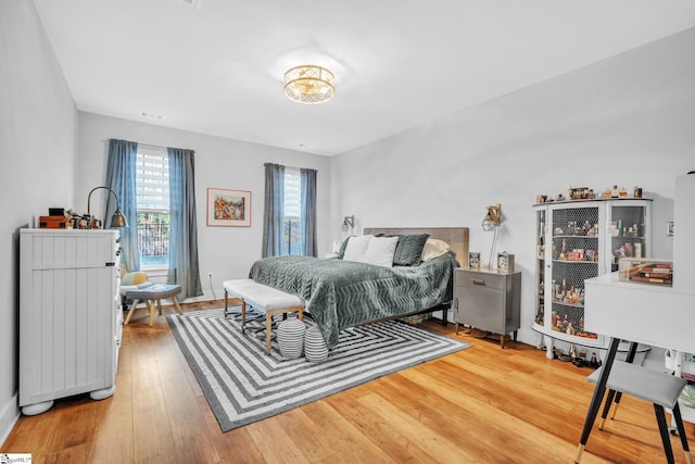 bedroom with hardwood / wood-style flooring