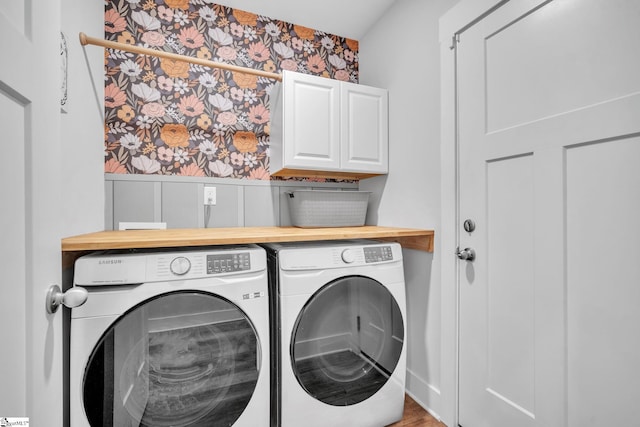 laundry area with cabinets and washer and clothes dryer