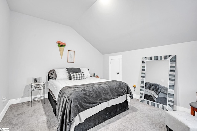 bedroom featuring carpet floors and vaulted ceiling