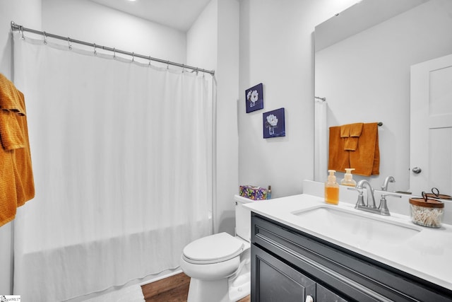 full bathroom featuring hardwood / wood-style floors, vanity, toilet, and shower / bath combination with curtain