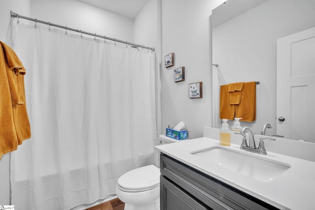 bathroom featuring hardwood / wood-style floors, vanity, and toilet