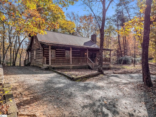 log-style house featuring covered porch