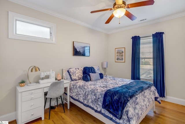 bedroom featuring multiple windows, ceiling fan, light hardwood / wood-style flooring, and ornamental molding