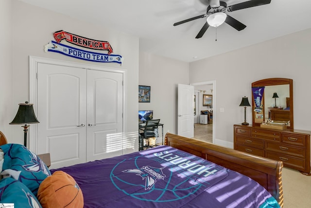 bedroom featuring ceiling fan, a closet, and light colored carpet