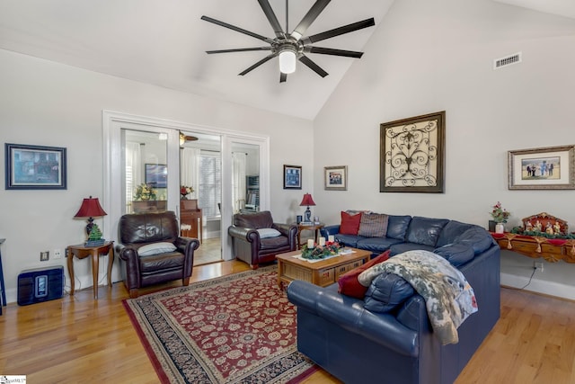 living room featuring high vaulted ceiling, light hardwood / wood-style flooring, and ceiling fan