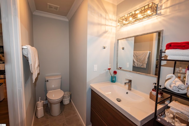 bathroom featuring tile patterned flooring, vanity, toilet, and crown molding