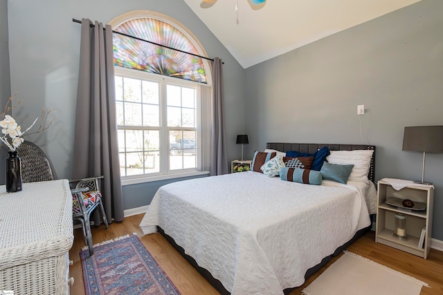 bedroom featuring light hardwood / wood-style floors, ceiling fan, and lofted ceiling