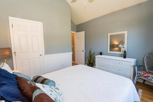 bedroom with hardwood / wood-style floors and high vaulted ceiling