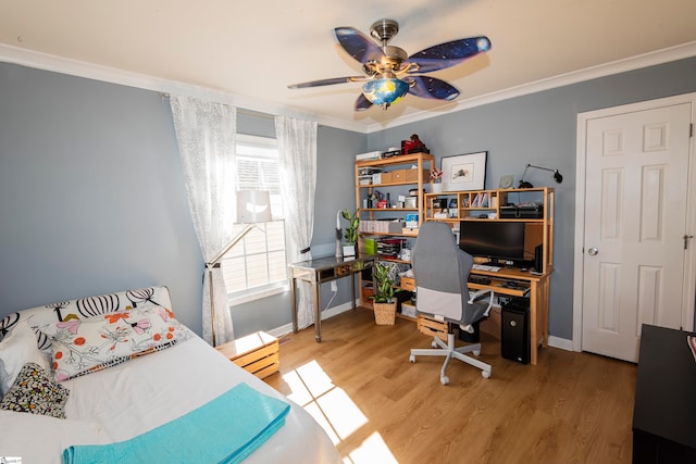 bedroom with hardwood / wood-style floors, ceiling fan, and crown molding