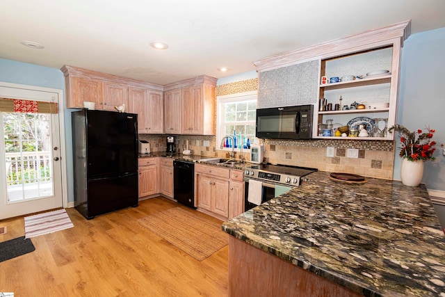 kitchen featuring light brown cabinetry, tasteful backsplash, sink, black appliances, and light hardwood / wood-style floors