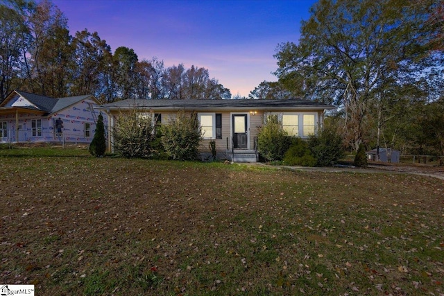 ranch-style house with a yard