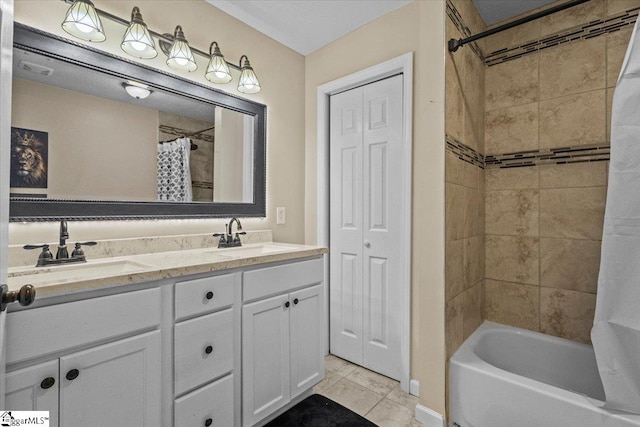 bathroom with tile patterned floors, vanity, and shower / tub combo